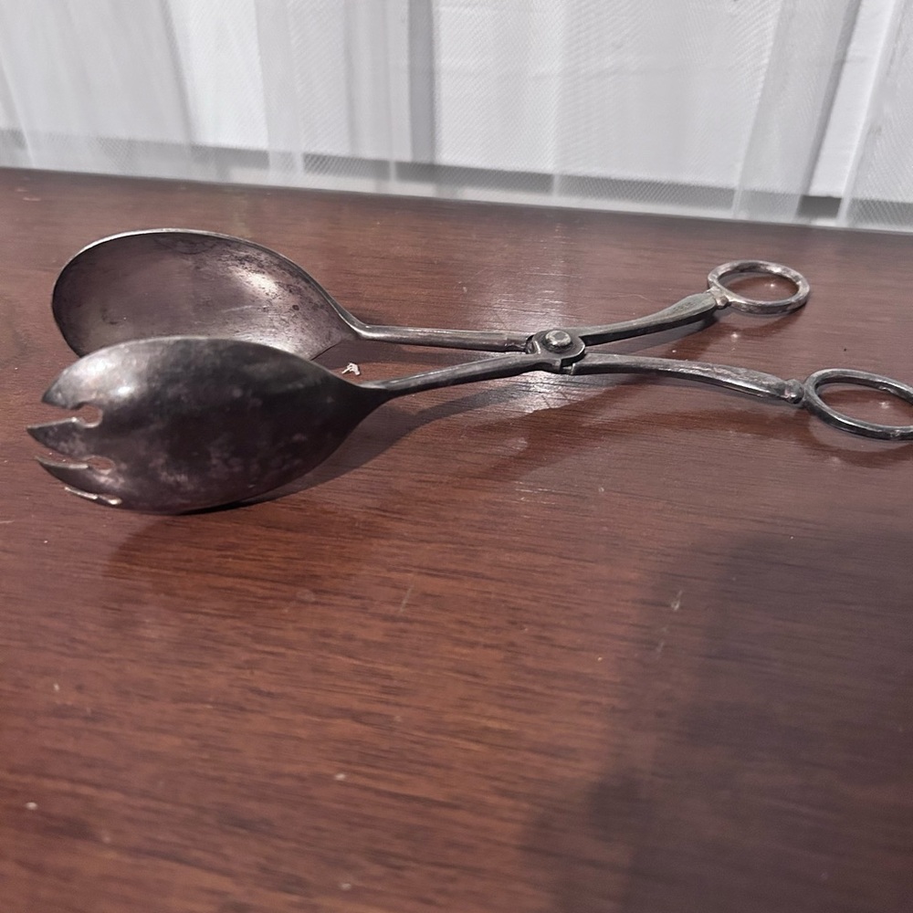 Vintage electroplated zinc alloy serving tongs with a scissor mechanism.